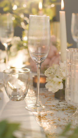 Vertical-Video-Close-Up-Of-Candles-And-Glasses-On-Vertical-Video-Of-Table-Set-For-Meal-At-Wedding-Reception-Or-Restaurant-1